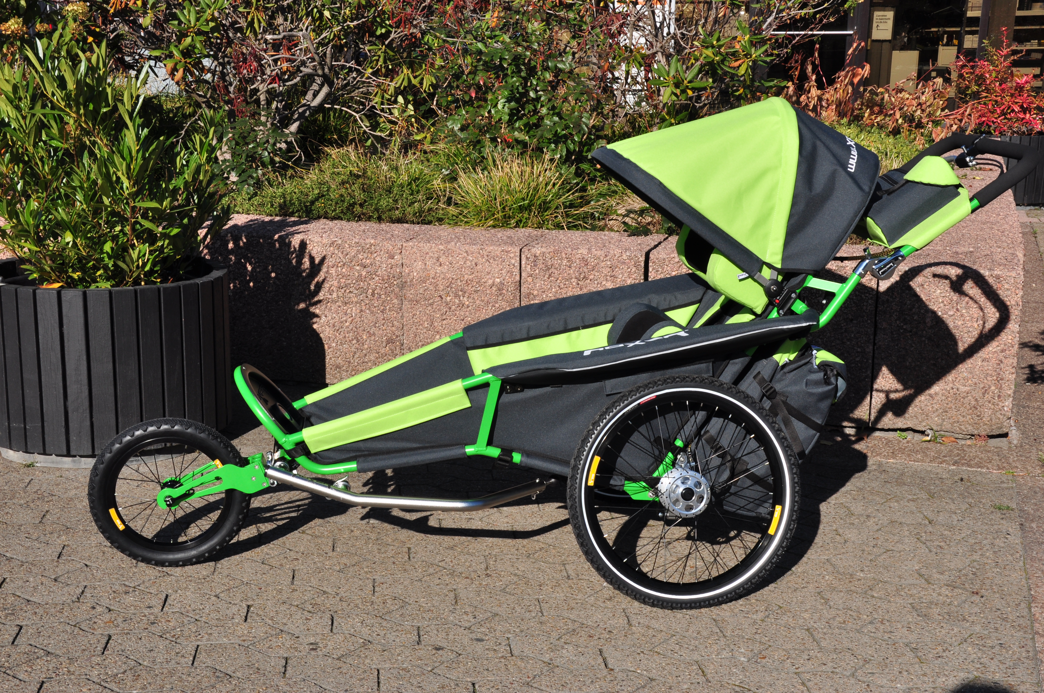 Adult jogger stroller on a forest path